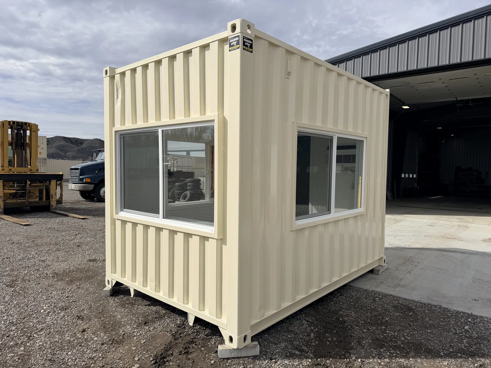 Windowed exterior of a custom gravel pit control office