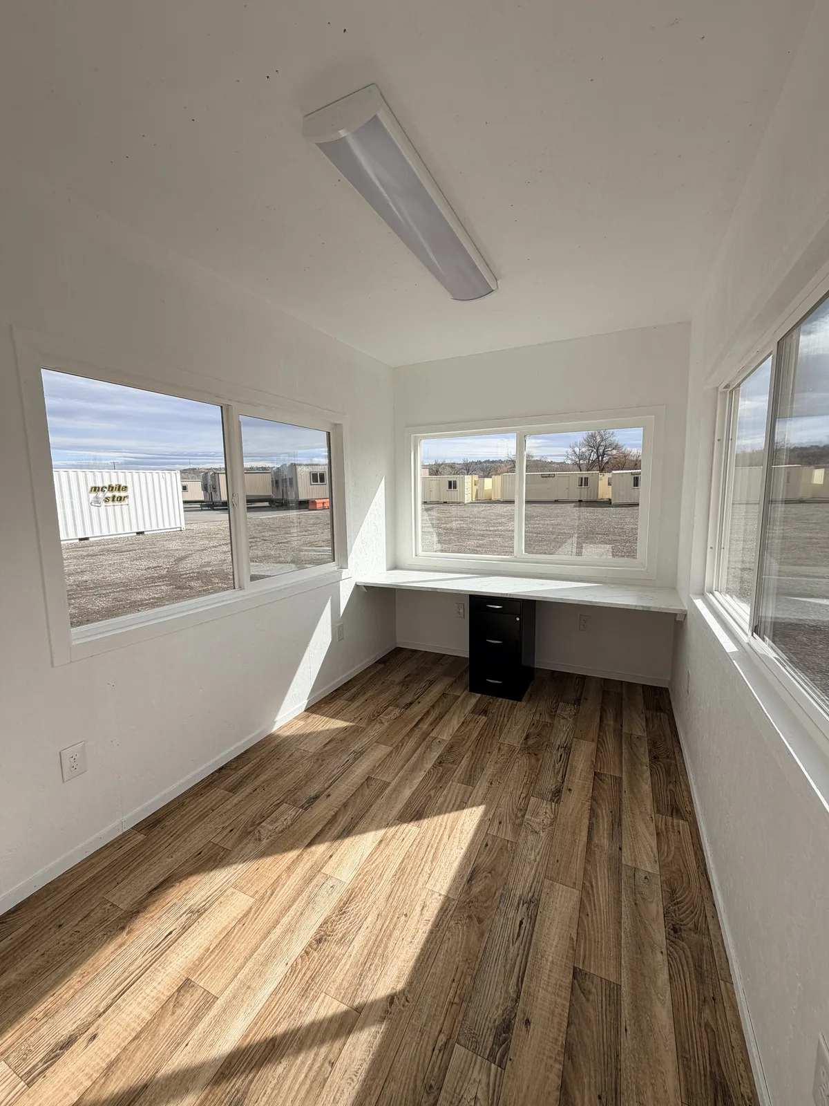 Control office interior with wraparound windows and desk