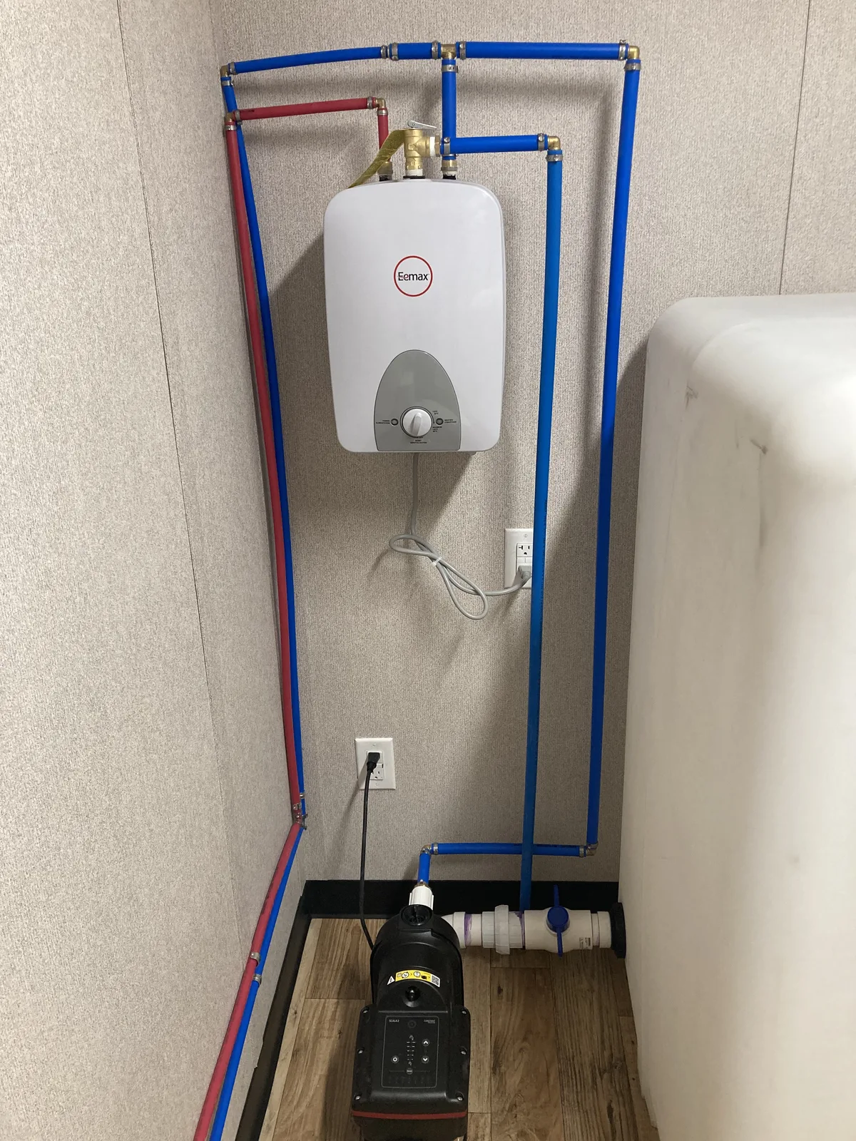 Water heater and plumbing system for a custom office bathroom