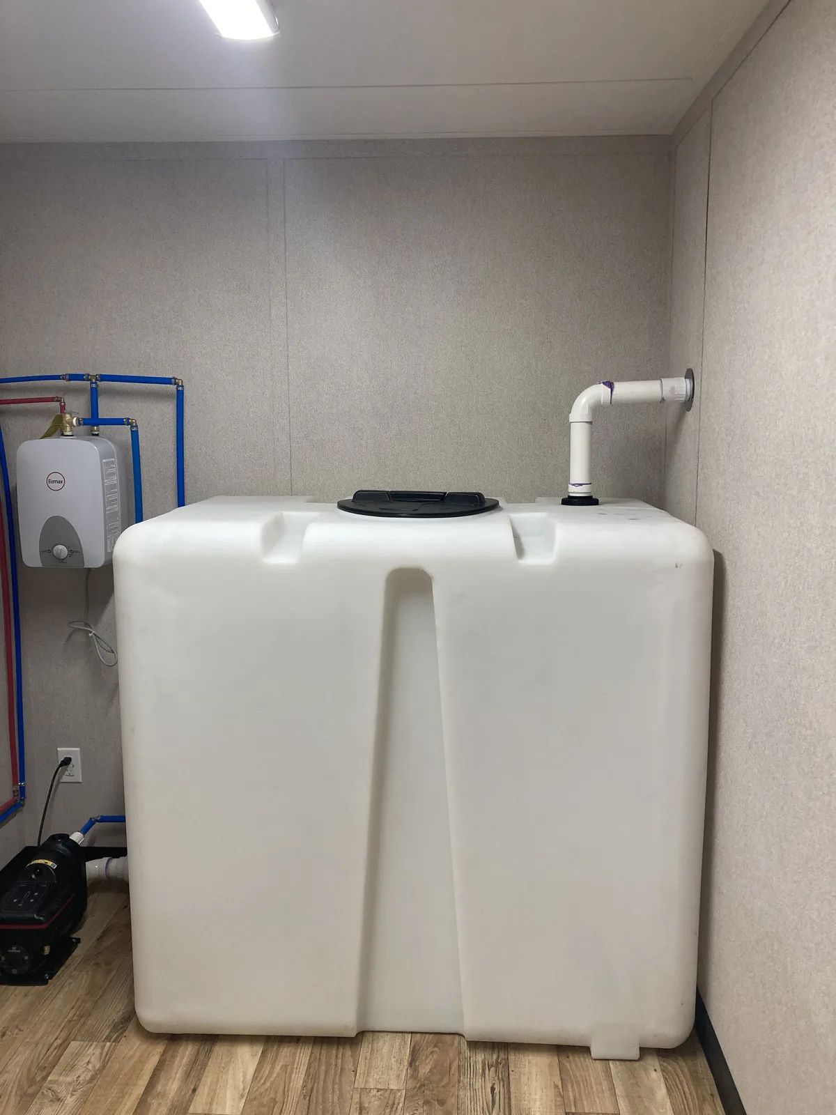Water storage system inside a custom office with bathroom