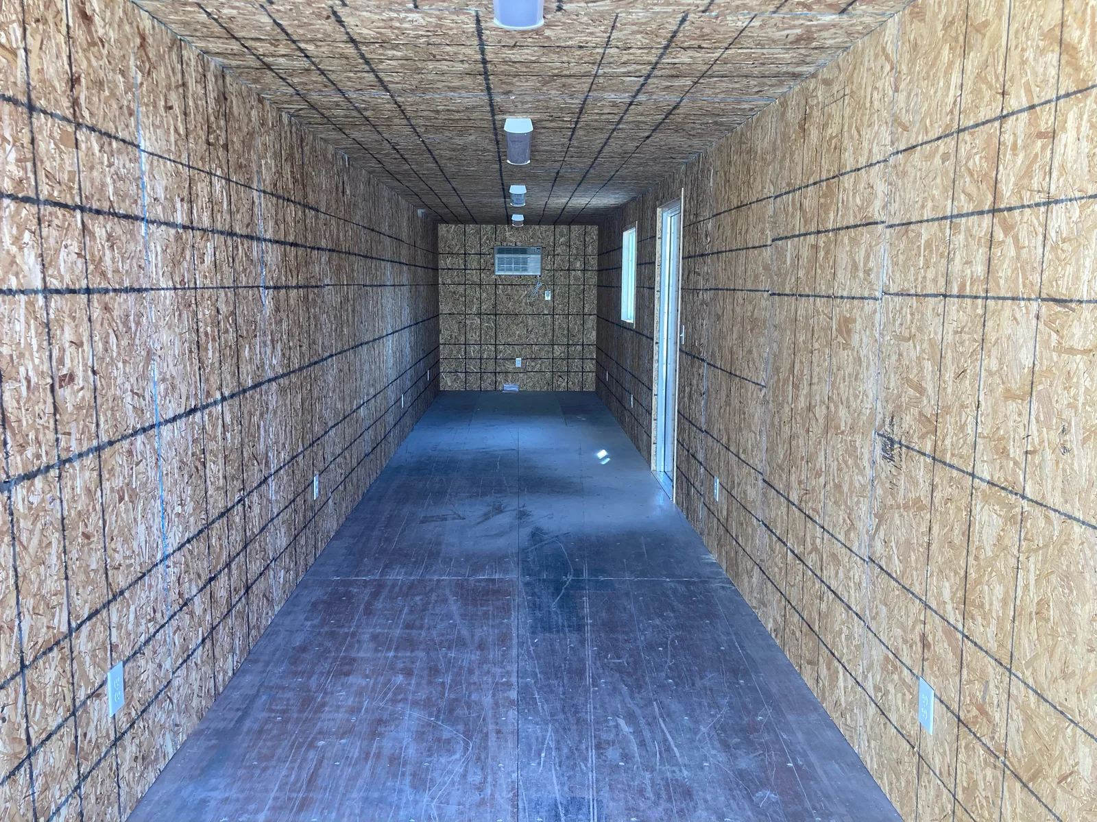 Full-length OSB-lined interior of a custom 8-by-40-foot unit