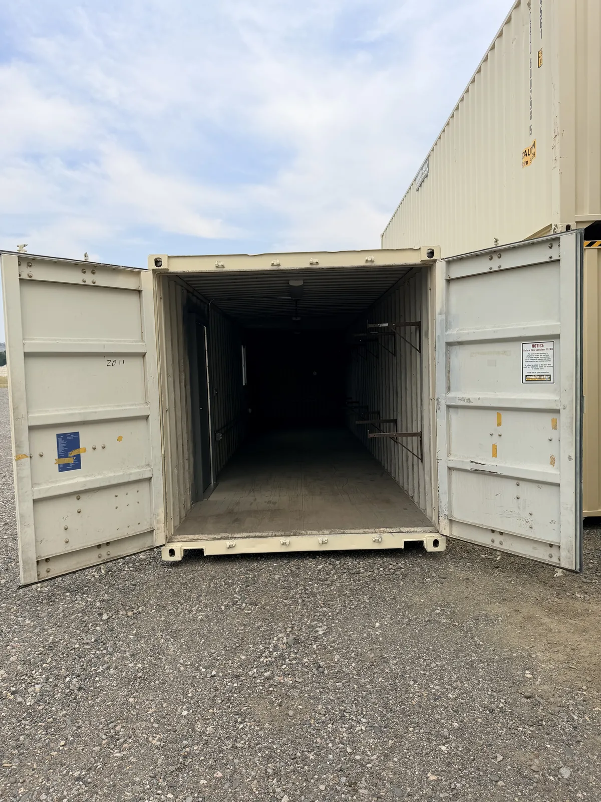 Shelf bracket storage interior viewed through open cargo doors