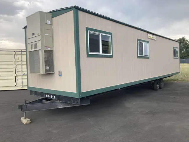 MO-116 10 by 36 foot mobile office exterior showing the trailer tongue, windows, and end-mounted climate-control equipment