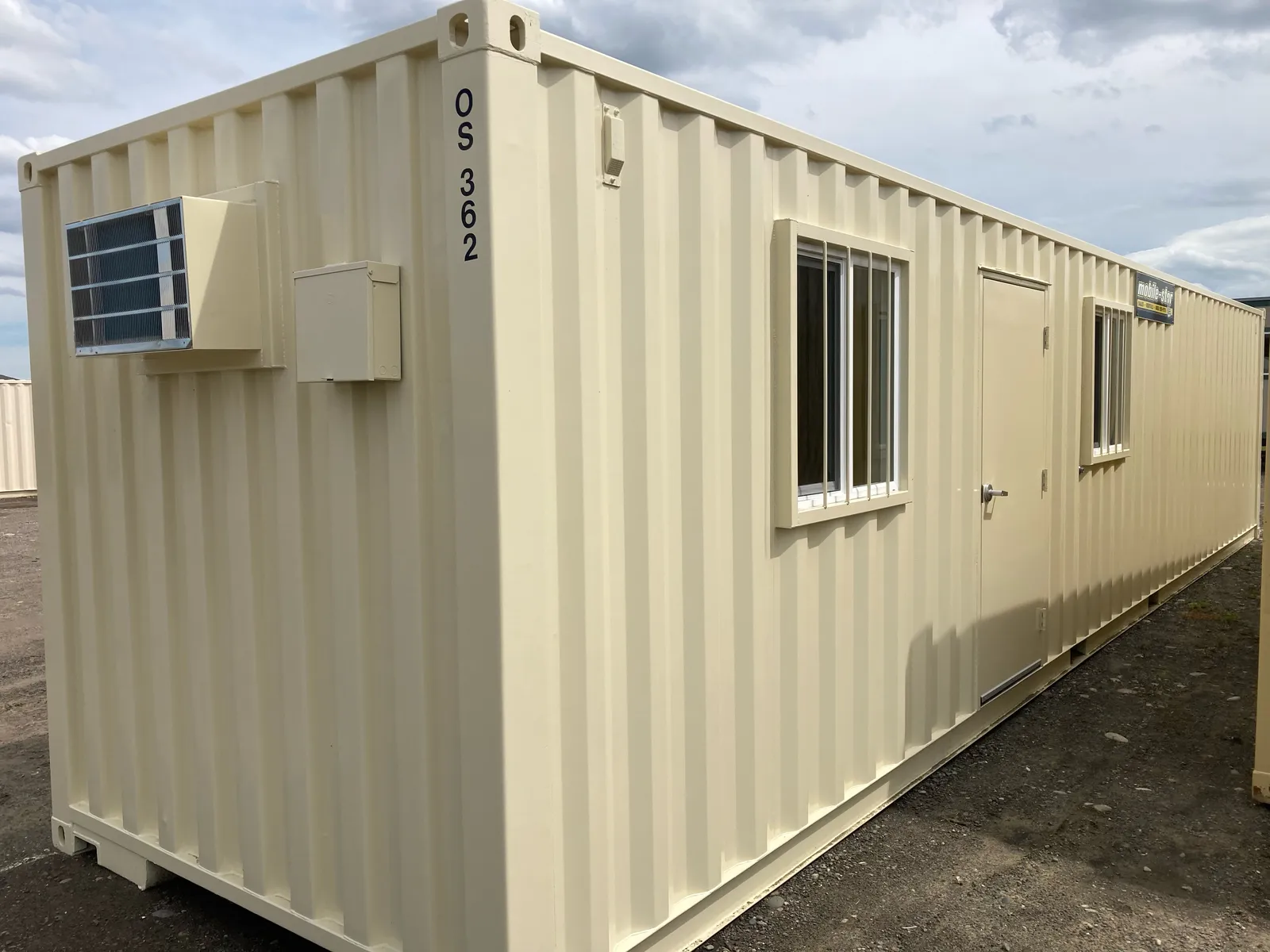 OS-362 tan office and storage combo container with personnel door, barred windows, and air conditioner