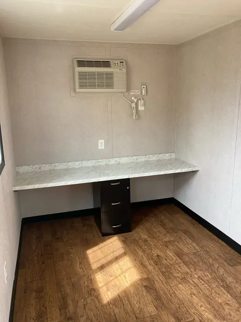 Built-in workstation inside OS-362 with marble-look counter, filing pedestal, window, lighting, outlets, and air conditioner