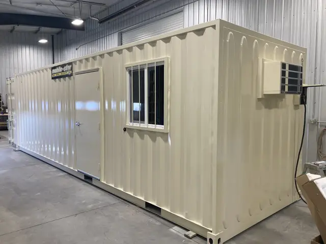 OS-365 8 by 28 foot office and storage container exterior showing the personnel door, barred window, and wall-mounted air conditioner