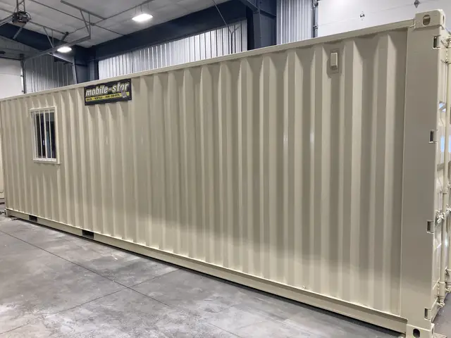 Storage-side exterior of OS-365 with Mobile-Stor branding, barred window, and cargo doors
