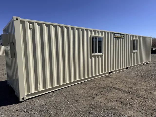 Rear exterior of the O-370 8 by 40 foot on-ground office with two barred windows