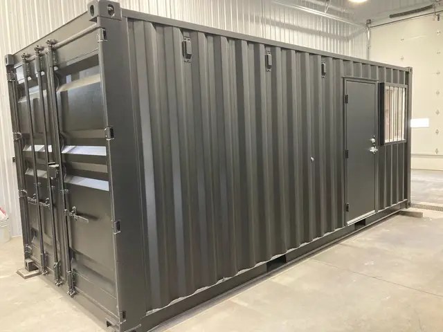 Charcoal container office with personnel door and barred window inside the Mobile-Stor shop