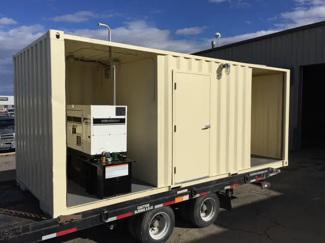 Custom generator enclosure mounted on a tandem-axle trailer with equipment doors open