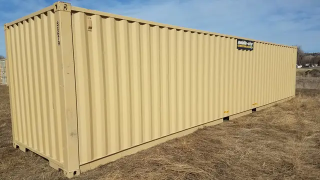 Tan 40-foot Mobile-Stor shipping container in a field