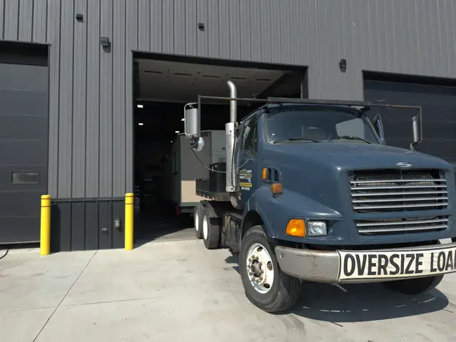 Front view of Mobile-Stor's branded blue delivery truck outside the Billings shop