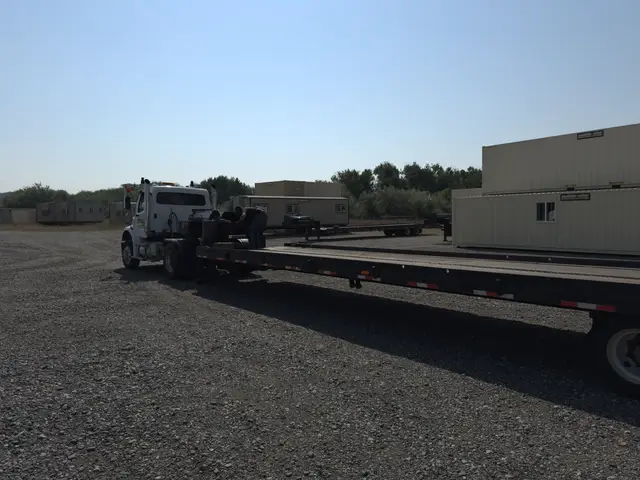 Mobile-Stor tilt-bed delivery truck ready to load a container