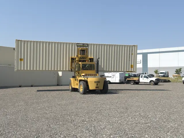 Forklift positioned in front of a white shipping container