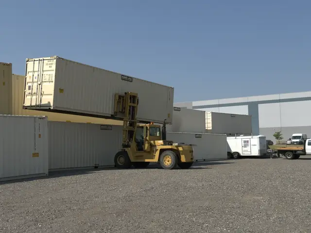 Forklift working beside stacked shipping containers in Mobile-Stor's Billings yard
