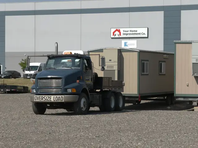 Side view of a Mobile-Stor truck hauling a mobile office