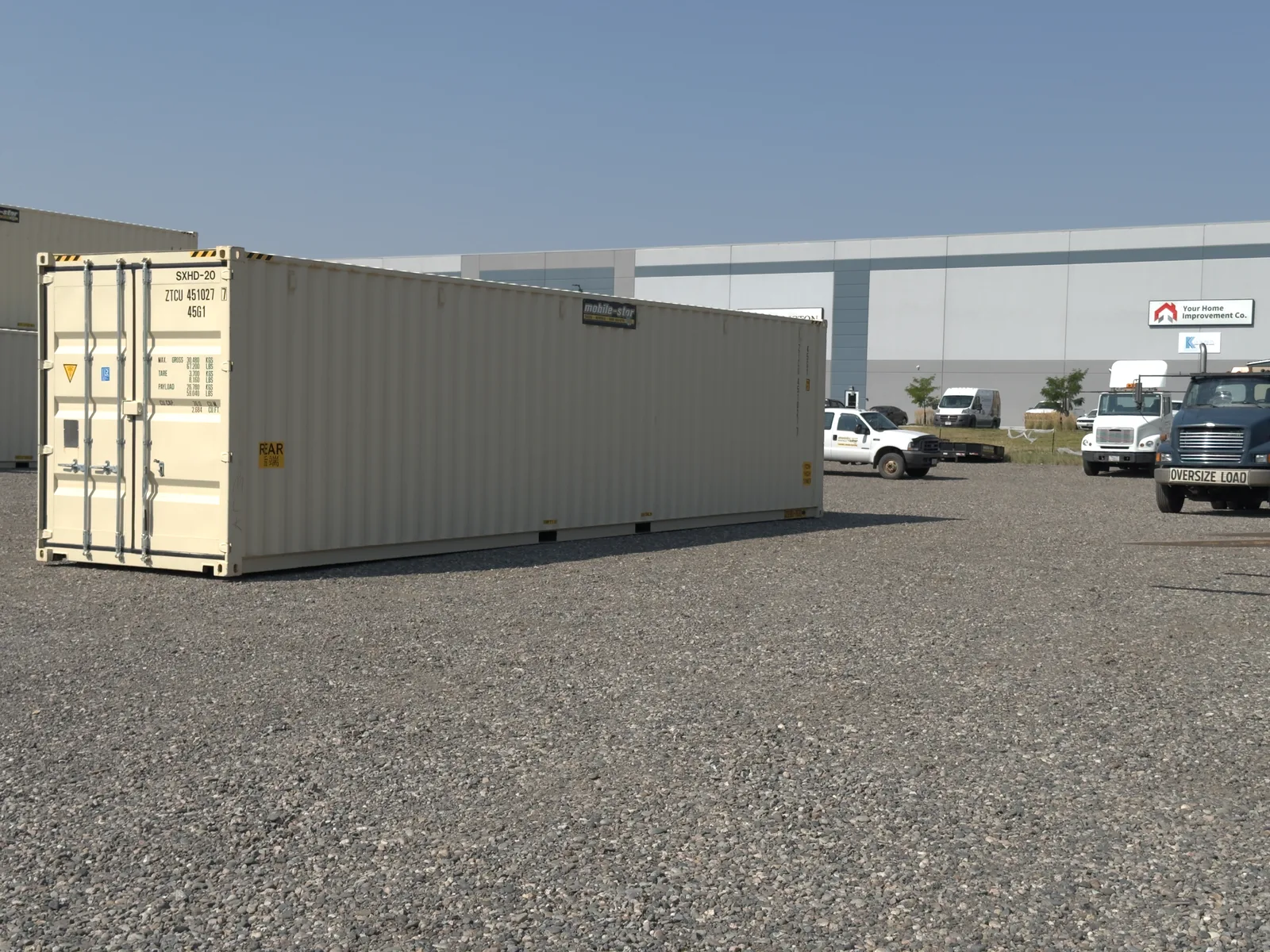 White 20-foot Mobile-Stor branded shipping container